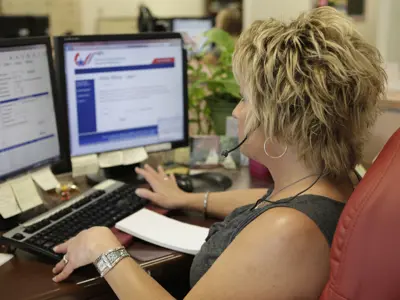 A woman at her desk on the computer working